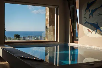a swimming pool with a view of the ocean at Caneva Luxury Villa in Tavronitis