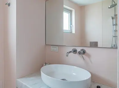 a white bath tub in a bathroom with a mirror at Tholaria Villa in Chania Town