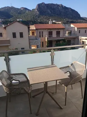 a table and chairs on a balcony with a view at Evriali Comfort Living in Palaiochóra