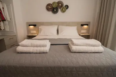 a bedroom with a bed with two towels on it at Evriali Comfort Living in Palaiochóra