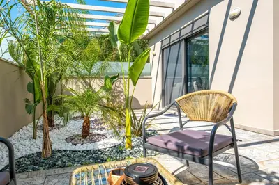 a patio with chairs and plants on it at Delight Luxury Residences - Souda in Souda