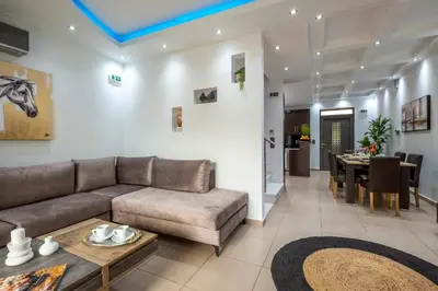 a living room with a couch and a table at Delight Luxury Residences - Souda in Souda