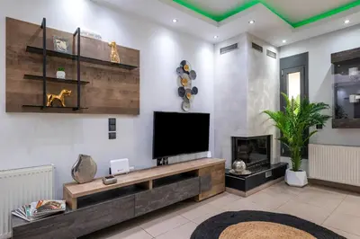 a living room with a television and a fireplace at Delight Luxury Residences - Souda in Souda