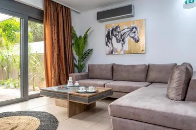 a living room with a couch and a table at Delight Luxury Residences - Souda in Souda