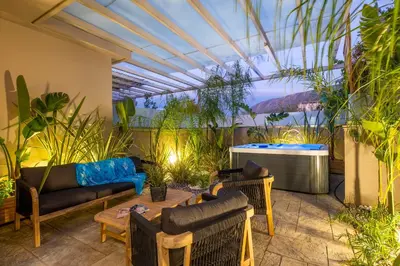 a patio with furniture and a hot tub at Delight Luxury Residences - Souda in Souda