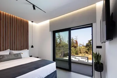 a bedroom with a bed and a large window at Horizon Luxury Villa in Chania Town