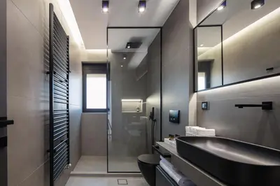 a bathroom with a black sink and a mirror at Horizon Luxury Villa in Chania Town
