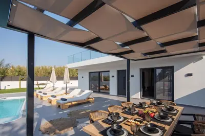 an open living room with a pool and a house at Horizon Luxury Villa in Chania Town