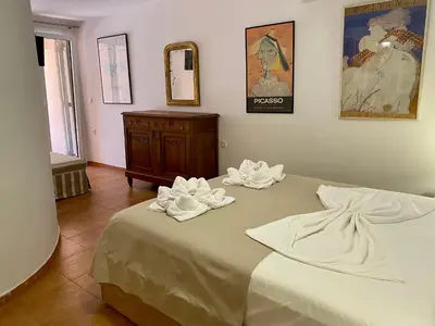 a bedroom with a bed with towels on it at RITSA ART RESIDENCE in Chania Town