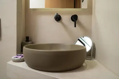 a bathroom with a large bowl sink and a mirror at Ontas IK18 in Chania Town