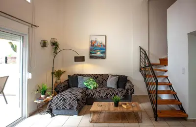 a living room with a couch and a table at Unique Apartment in Chania Town