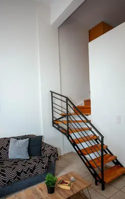 a spiral staircase in a living room with a couch at Unique Apartment in Chania Town