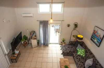 a living room with a couch and a tv at Unique Apartment in Chania Town