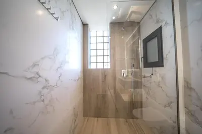a bathroom with a shower with a glass door at Villa Olira in Alikianós