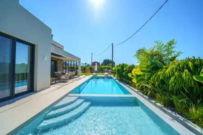 an image of a swimming pool in a house at Villa Olira in Alikianós