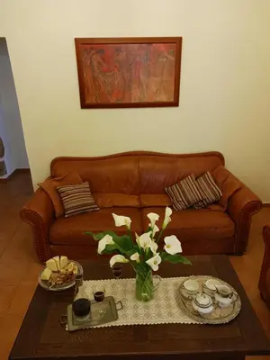 a living room with a couch and a table with flowers at casa di nonna in Chania Town
