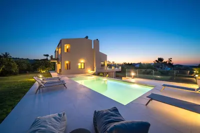 a villa with a swimming pool at night at Villa Florentina at Chania Suburbs With Private Pool and BBQ in Alikianós