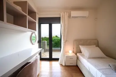 a bedroom with a bed and a window with a balcony at Villa Florentina at Chania Suburbs With Private Pool and BBQ in Alikianós