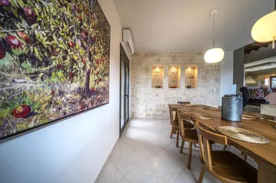 a dining room with a large painting on the wall at Villa Florentina at Chania Suburbs With Private Pool and BBQ in Alikianós