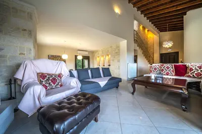 a living room with a couch and a table at Villa Florentina at Chania Suburbs With Private Pool and BBQ in Alikianós