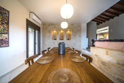 a dining room with a wooden table and chairs at Villa Florentina at Chania Suburbs With Private Pool and BBQ in Alikianós