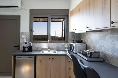 a kitchen with a sink and a microwave at Thea Studio in Agios Padeleimon