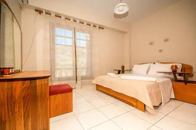 a bedroom with a bed and a large window at Strevagio family house in Kissamos