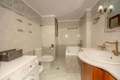a bathroom with a sink and a toilet and a tub at Strevagio family house in Kissamos