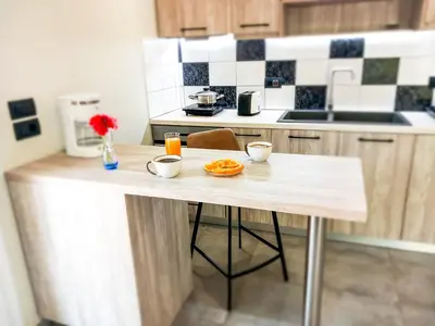 a kitchen with a table with food on it at Yucca Studio, beautiful apartment with garden in Ropanianá