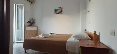 a bedroom with a bed and a desk and a window at Paradise in Agia Roumeli