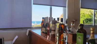 a counter with lots of bottles of wine on it at Paradise in Agia Roumeli