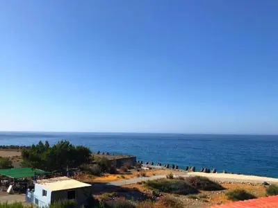 a view of a beach with the ocean in the background at Paradise in Agia Roumeli