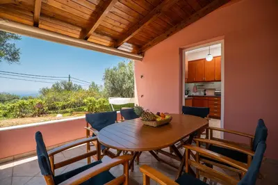 a dining room with a table and chairs and a window at Villa Silva, Garden & Sea View, 3 BR, -10 min drive from center in Chania Town
