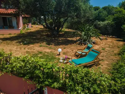a pair of lounge chairs in a yard at Villa Silva, Garden & Sea View, 3 BR, -10 min drive from center in Chania Town