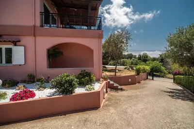 a pink house with flowers in front of it at Villa Silva, Garden & Sea View, 3 BR, -10 min drive from center in Chania Town