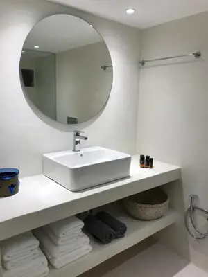 a white bathroom with a sink and a mirror at Fourteen All Seasons House in Chania Town