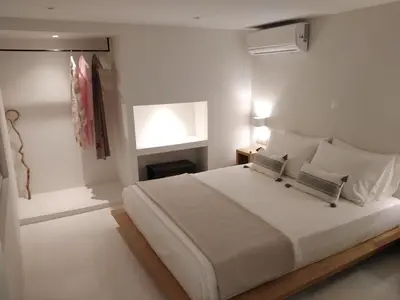 a bedroom with a large white bed and a window at Fourteen All Seasons House in Chania Town
