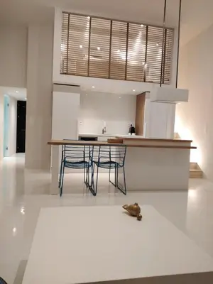 a kitchen with a table and chairs on a white floor at Fourteen All Seasons House in Chania Town