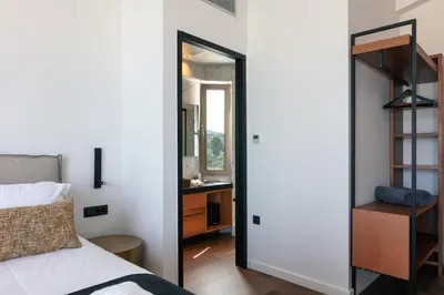 a bedroom with a bed and a desk with a mirror at Villa Alveo Del Mare in Chania Town
