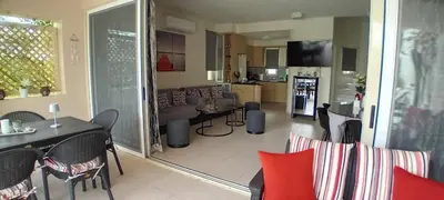 a kitchen and a living room with a table and chairs at Villa Rodo in Pírgos Psilonérou