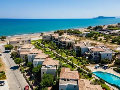 an aerial view of a resort with a pool and the beach at Villa Rodo in Pírgos Psilonérou