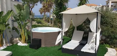 a gazebo with a chair and a hot tub at Villa Rodo in Pírgos Psilonérou