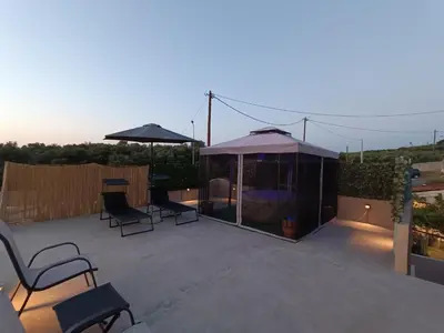 a patio with chairs and a gazebo at Vrachakia Elegant in Ayiá