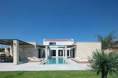 a pool in the backyard of a house at Ikritis Villas in Chorafakia