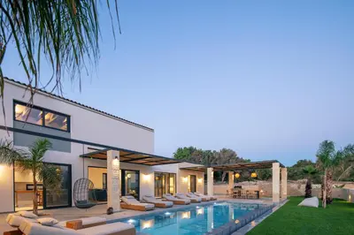 an exterior view of a house with a swimming pool at Ikritis Villas in Chorafakia