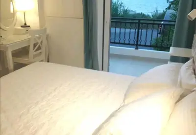 a bedroom with a bed with a view of a balcony at Ocean View in Chania Town