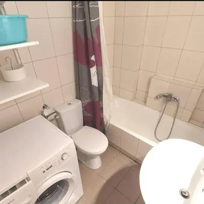 a bathroom with a toilet and a washing machine at Ocean View in Chania Town