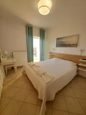 a bedroom with a large bed and a window at Ocean View in Chania Town