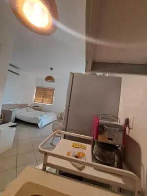 a kitchen with a refrigerator and a living room at Ocean View in Chania Town