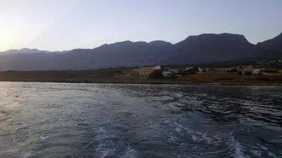 a body of water with mountains in the background at Kritamos Beach Apartments in Frangokastello